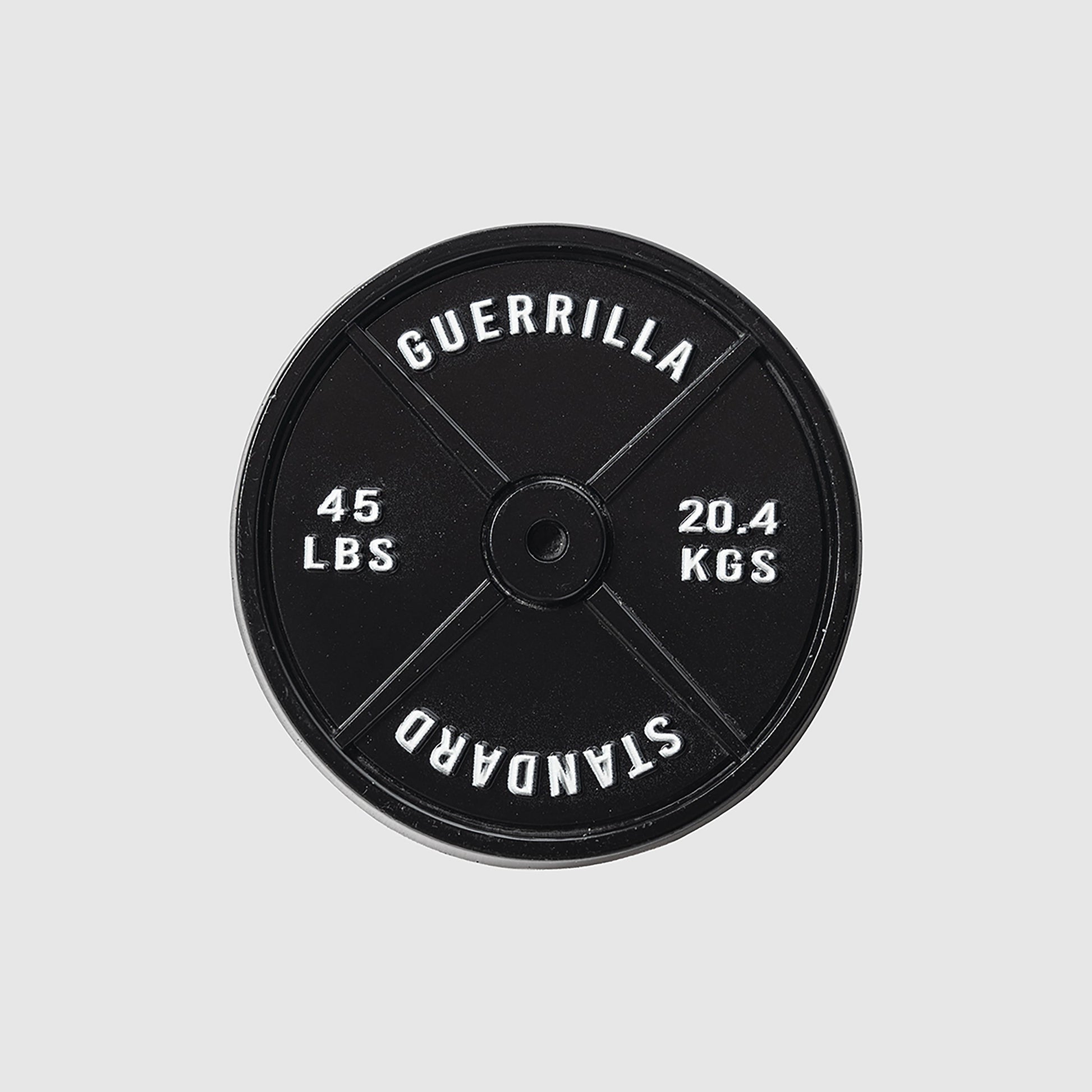 A black 45lb Plate Ball Marker by Guerrilla Golf, featuring "GUERRILLA STANDARD" along with weight markings of 45 LBS and 20.4 KGS in crisp white text against a light gray backdrop—its robust design evokes the industrial strength of a manhole cover.