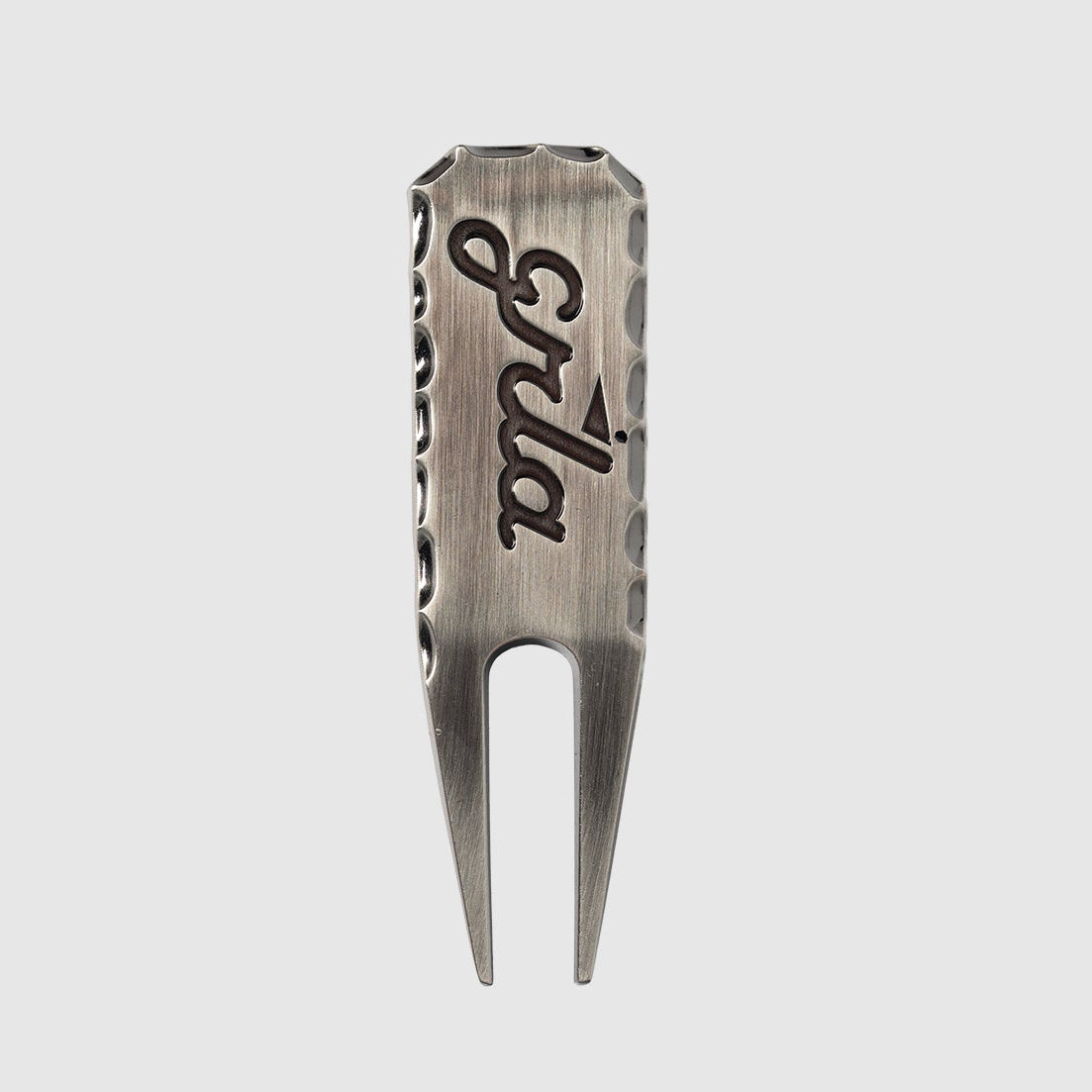 The GRLA Raw Divot Tool by Guerrilla Golf is a sleek metal golf accessory featuring two prongs, with "Erika" engraved on the front alongside the GRLA logo, set against a plain light gray background.