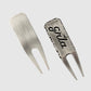 Two GRLA Raw Divot Tools by Guerrilla Golf, crafted from metal with a brushed finish—one featuring the smooth reverse and the other highlighting a textured face engraved with the bold black GRLA logo. This must-have accessory seamlessly blends durability and style for every golfer.