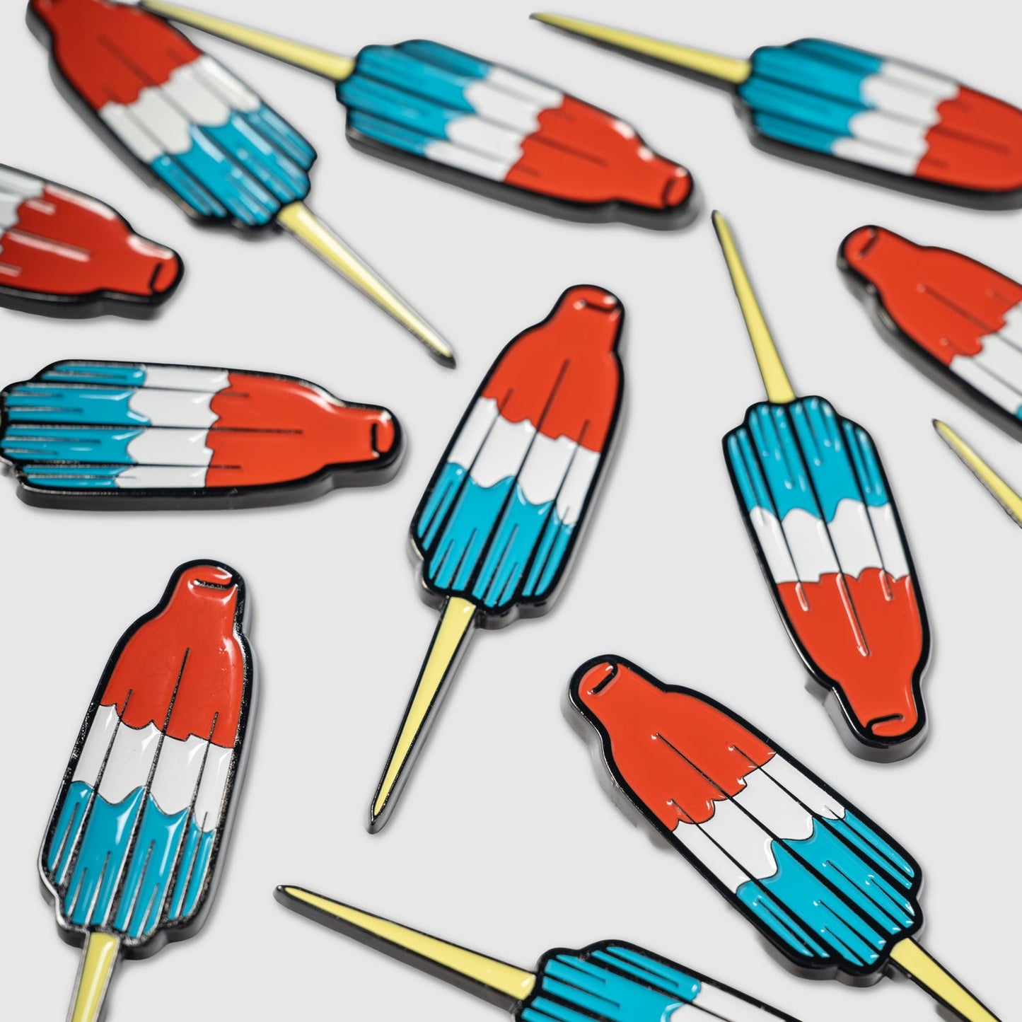 Guerrilla Golf’s Rocket Pop Divot Tool, featuring vibrant red, white, and blue rocket-shaped designs with yellow pin backs, offers a playful nod to childhood nostalgia—making it the perfect golf accessory for anyone looking to add a whimsical touch to their game.