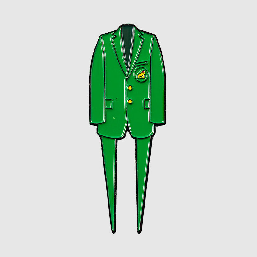 The Green Coat Divot Tool by Guerrilla Golf, inspired by the iconic Masters Tournament jacket with its green blazer shape, yellow buttons, and chest badge detailing, makes a unique golf accessory and is shown on a plain gray background.