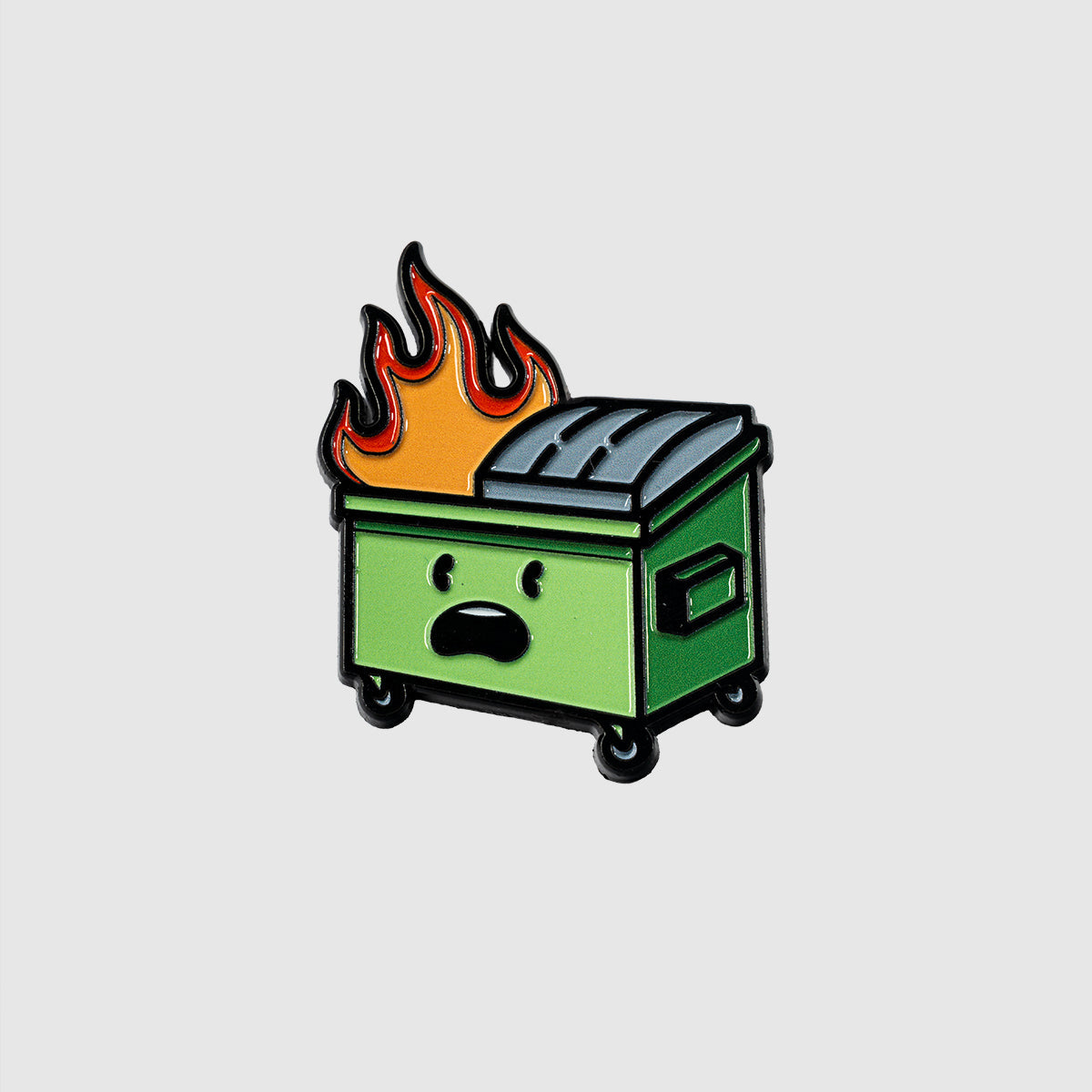 The Guerrilla Golf "Dumpster Fire" features a cartoon green dumpster with a surprised face, its lid half open and vivid flames rising from the top—perfectly capturing the chaotic spirit of a classic dumpster fire.