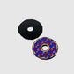 Two Donut Ball Markers by Guerrilla Golf are on display: one features a solid black design, while the other is adorned with a blue and red pattern accented with gold circles. Both markers are presented against a plain, light background.