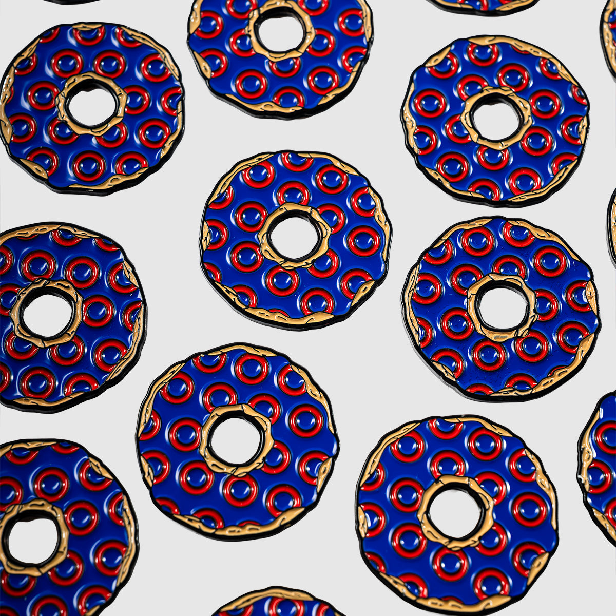 Evenly spaced across a white background, the design features circular blue Donut Ball Markers by Guerrilla Golf, each accented with red dots and gold outlines. With a central hole reminiscent of stylized wheels or decorated disks, these markers are arranged in a consistent pattern.
