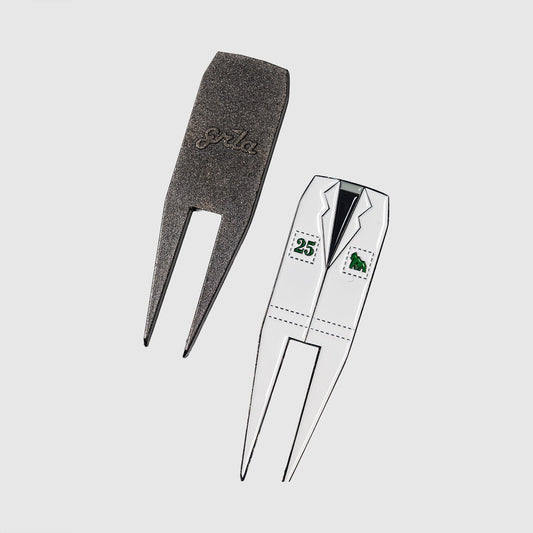 Showcased here are two Guerrilla Golf Caddy divot tools—ideal golf gifts for any enthusiast. One features a textured, engraved finish with the Guerrilla Golf branding, while the other stands out as a unique divot repair tool styled like a white suit jacket with lapels and two green postage-stamp details. Both are displayed against a plain white background, making this stylish set an eye-catching addition to any golfer’s collection.