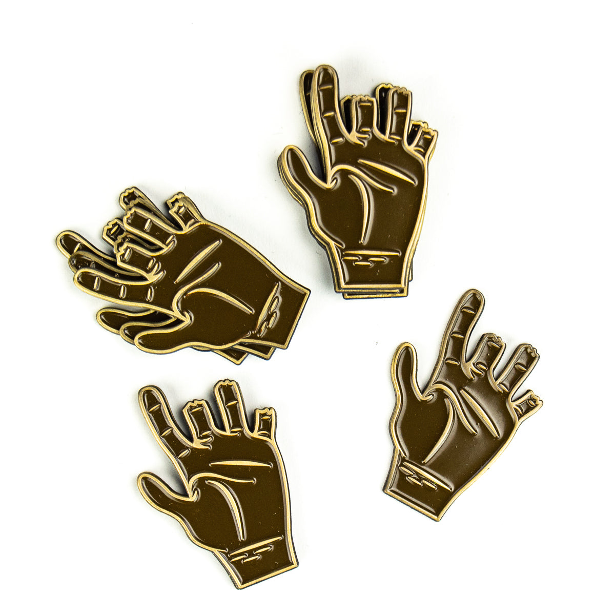 Four Guerrilla Golf Chubbs Ball Marker enamel pins, each shaped like a stylized brown hand in a different finger gesture and outlined in gold, are arranged on a white background. These unique pins double as distinctive ball markers on the green or serve as thoughtful keepsakes to commemorate a special game.