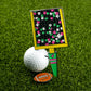A Logie Joe's Golf Field Goal Divot Tool with a colorful, rectangular design includes a removable football ball marker, resting on grass.