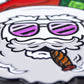 The Santa the Degenerate Ball Marker by Pins and Aces features a cartoon Santa with white hair, a beard, purple sunglasses, and a cigar. This magnetic marker makes a fun Christmas golf accessory.