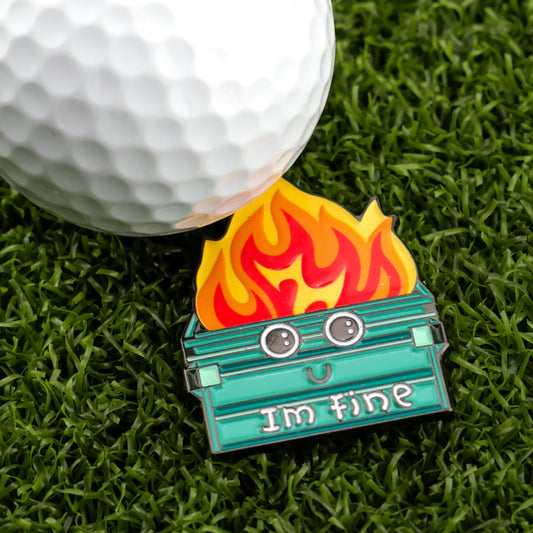 The Logie Joe's Golf Dumpster Fire Ball Marker, a funny enamel pin of a smiling dumpster on fire with 