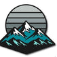 Experience the Mountain Moonrise Ball Marker by Logie Joe's Golf—a stylized illustration of snow-capped mountains set against a large, striped, gray circle evoking a dramatic sunset or moonrise. This nature-inspired golf accessory is the perfect choice for outdoor enthusiasts seeking a unique and functional addition to their game.