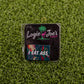 A small Logie Joe's Golf package featuring the "I Eat *ss Tropical" label and a colorful sticker sits on green turf—ideal for golf fans seeking funny accessories like a quirky divot tool or ball marker.