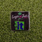 The “F” It golf ball marker from Ballmarkers by Logie Joe’s features a cartoon figure kicking the word It on grass, adding a humorous touch to your collection.