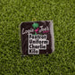 A premium ball marker from Logie Joe's Golf, featuring a palm tree logo and the phrase "Foxtrot Uniform Charlie Kilo" in bold black letters—a humorous addition to any golfer’s collection.