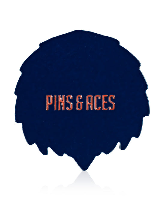 A dark blue, leaf-shaped Independence Eagle ball marker by Pins and Aces with bold orange branding—a perfect patriotic accessory to add flair to your Fourth of July golf game.