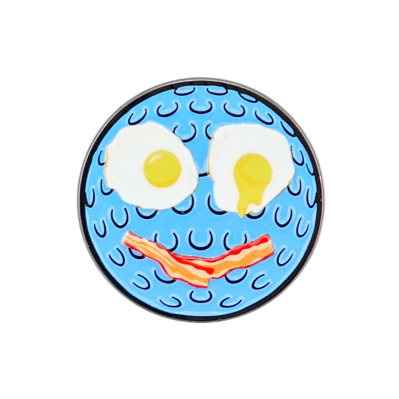 Logie Joe's Golf "Breakfast Ball" is a blue, textured smiley face ball marker with fried egg eyes and a bacon strip mouth on a plain white background—a playful, premium choice for unique golf accessories.