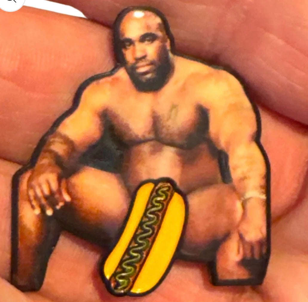 Introducing the Big Glizzy Ball Marker by Tee Bumps—a hilarious artwork featuring a cutout of a muscular, seated man with a hot dog graphic playfully placed over his crotch, held between your fingers. This quirky accessory is sure to become a legendary tribute on the course and makes for an unforgettable golf ball marker.