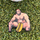 Show your sense of humor on the green with the Big Glizzy Ball Marker from Tee Bumps—a playful golf accessory featuring a muscular man sitting nearly nude on artificial grass, cleverly covered with a cartoon hot dog for an eye-catching look. This fun and bold legend tribute is sure to be a conversation starter at your next round.