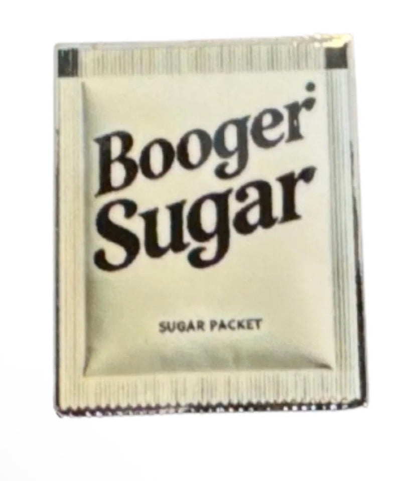 A small beige packet labeled Booger Sugar in bold letters, with Sugar Packet printed at the bottom, this Tee Bumps Booger Sugar Ball Marker captures classic diner vibes by cleverly mimicking a standard sugar packet—but with a playful golf-inspired twist.