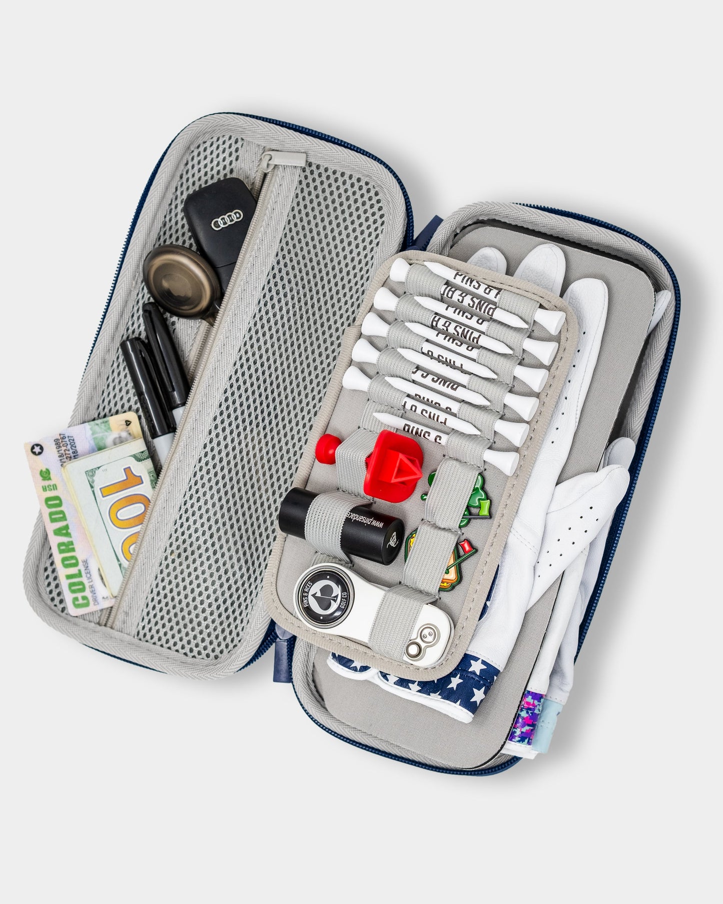 The Pins and Aces Glove & Accessory Caddie - Navy keeps golf tees, ball markers, gloves, cash, pens, keys, and more neatly organized in versatile compartments and mesh pockets.