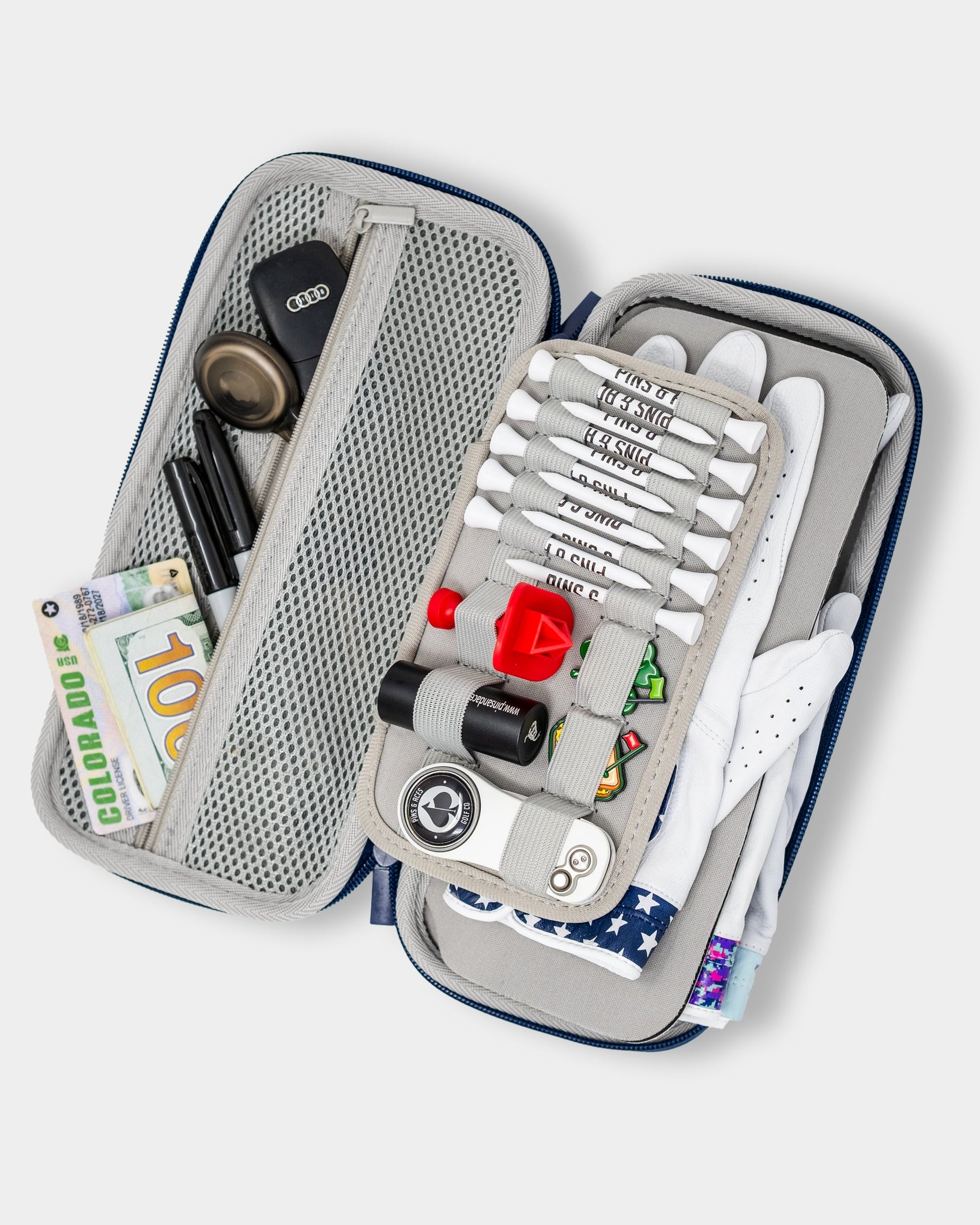 The Pins and Aces Glove & Accessory Caddie - Navy keeps golf tees, ball markers, gloves, cash, pens, keys, and more neatly organized in versatile compartments and mesh pockets.