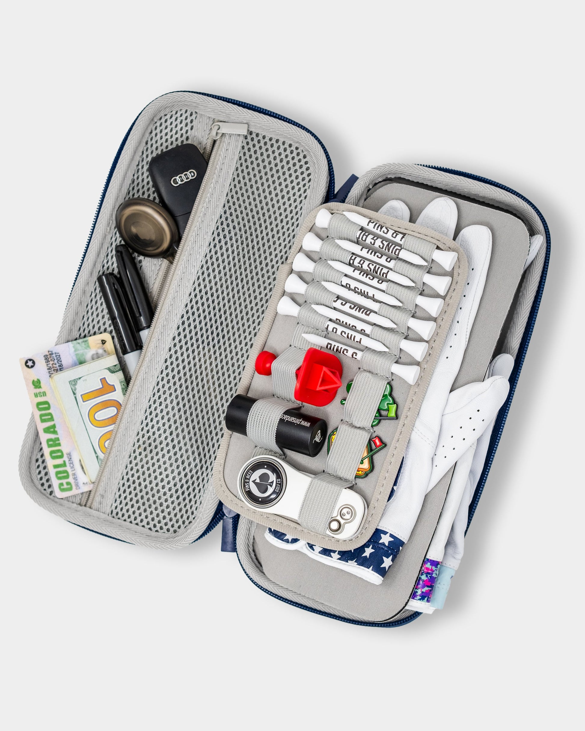 The Pins and Aces Glove & Accessory Caddie - Navy keeps golf tees, ball markers, gloves, cash, pens, keys, and more neatly organized in versatile compartments and mesh pockets.