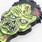 A close-up of the Mutant Zombie - Ball Marker by Pins and Aces, featuring a vibrant cartoon zombie head with green skin and angry eyes, designed as a colorful magnetic golf accessory for collectors, shown on a white background.