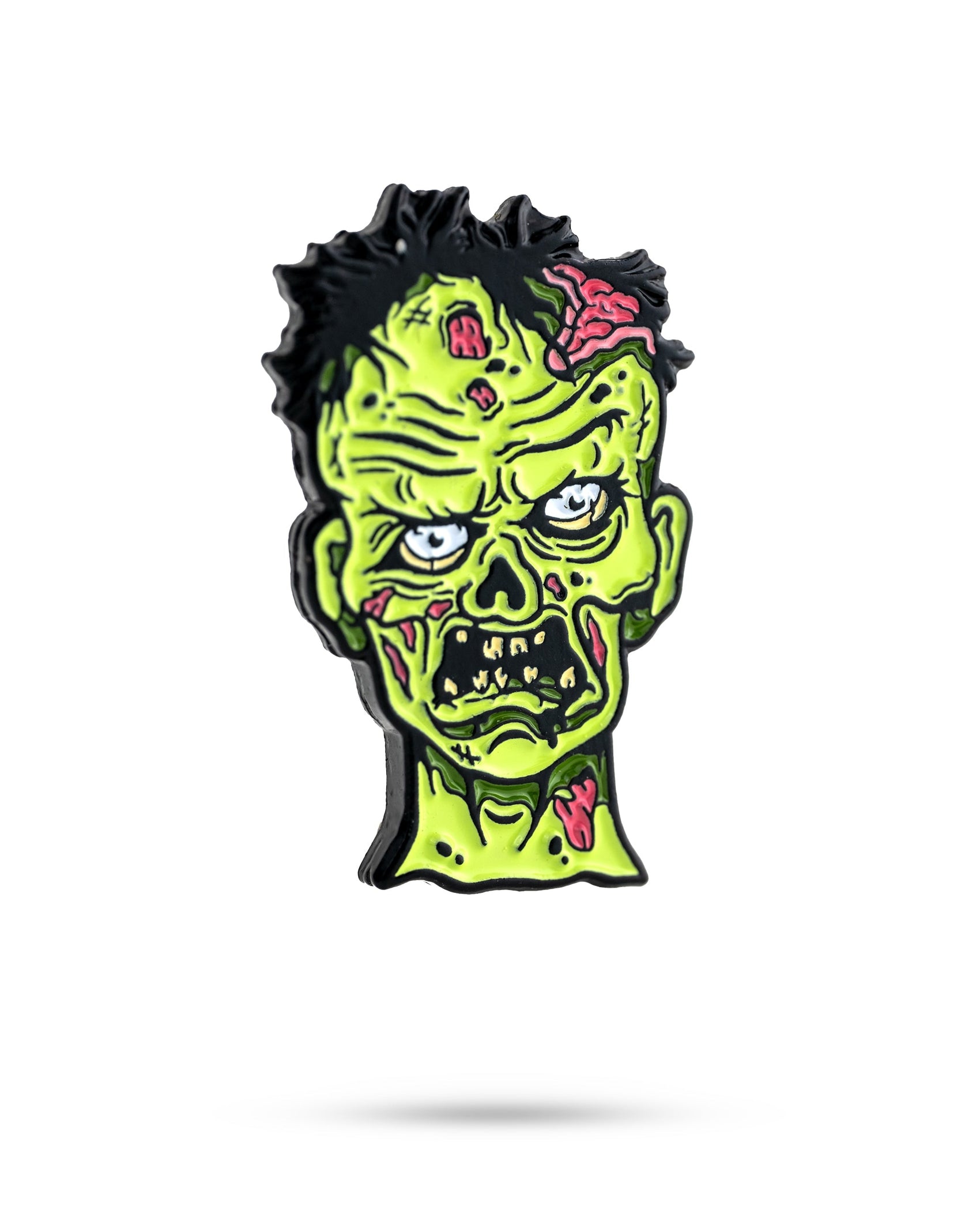 The Mutant Zombie - Ball Marker by Pins and Aces features a cartoonish zombie head with green skin, exposed brain, messy black hair, and exaggerated features—ideal for fans or collectors of unique cast steel ball markers.