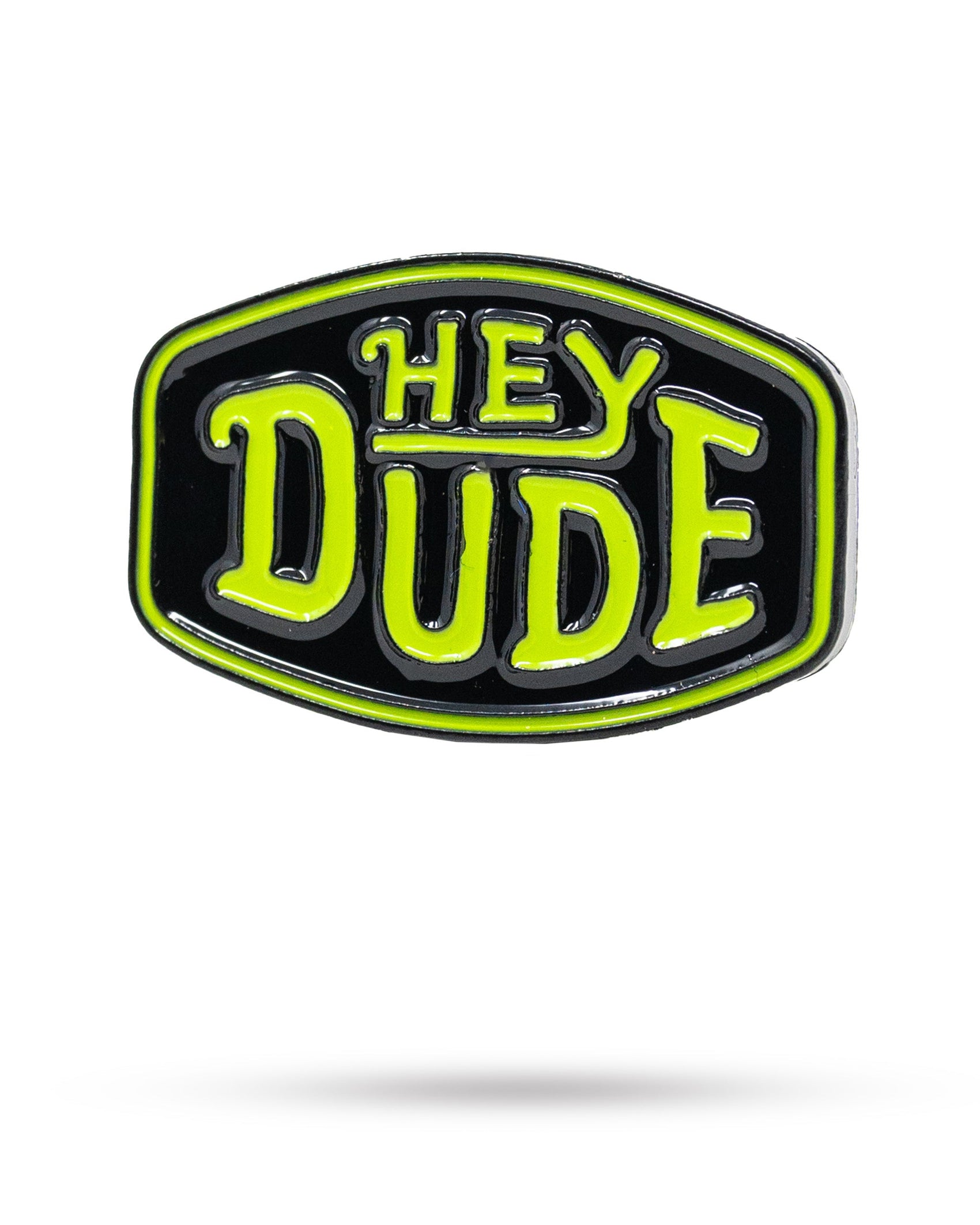 The HEYDUDE - Logo Ball Marker by Pins and Aces features a cast metal design with a black background, neon green border, and bold neon green "HEY DUDE" lettering—an iconic addition to the Pins and Aces ball markers collection.