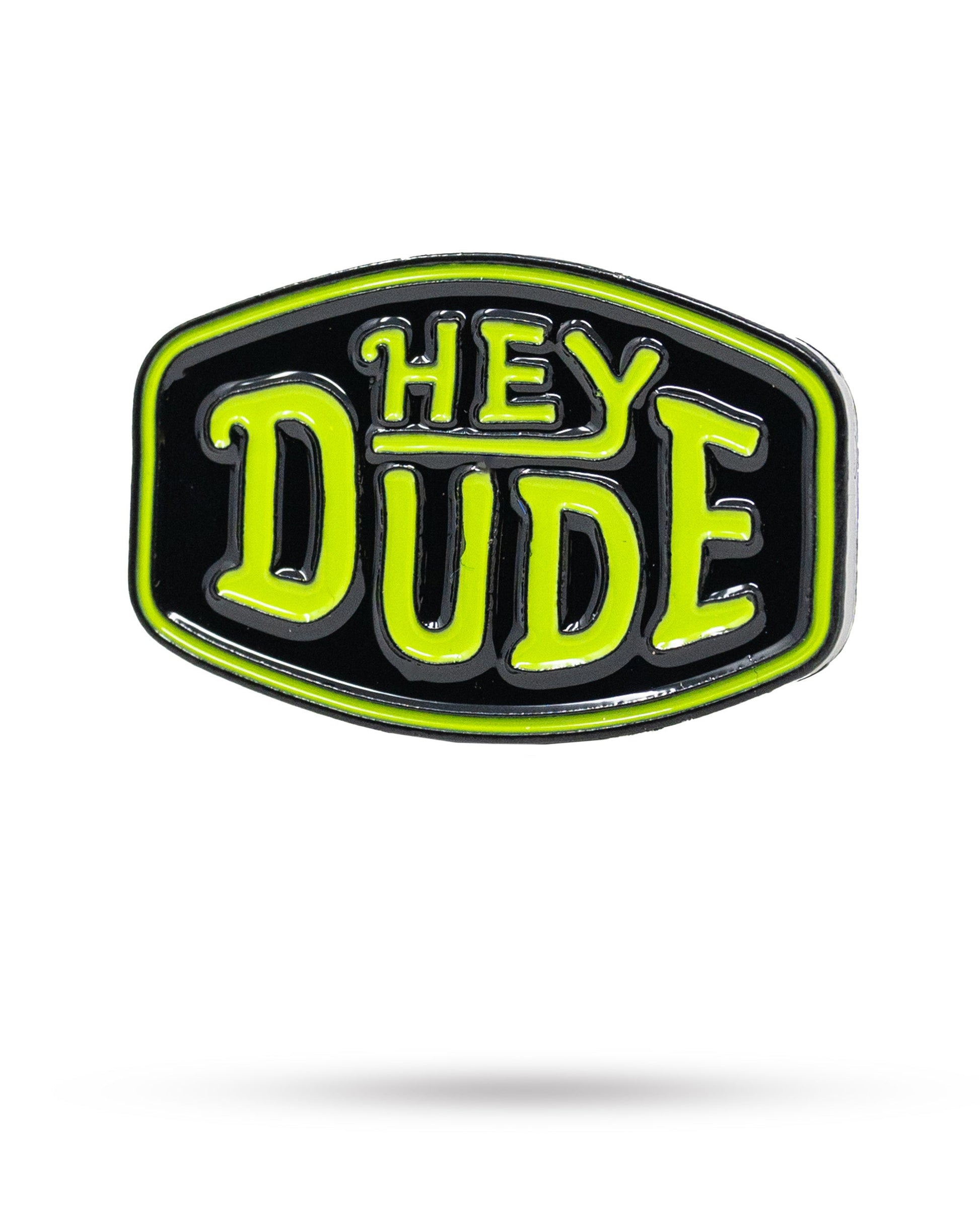 The HEYDUDE - Logo Ball Marker by Pins and Aces features a cast metal design with a black background, neon green border, and bold neon green "HEY DUDE" lettering—an iconic addition to the Pins and Aces ball markers collection.