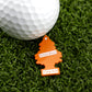 The Hitten Trees Orange Slice keychain from Ballmarkers.com, shaped like an orange tree and labeled with its name, rests on green turf beside a white golf ball—ideal for those seeking unique or humorous golf ball markers.