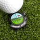 A golf ball sits on green grass beside the Logie Joe's Golf Hunting Birdies Ball Marker, which features a golf course illustration, a red flag, and the text HUNTING BIRDIES—a top funny golf accessory for your game.