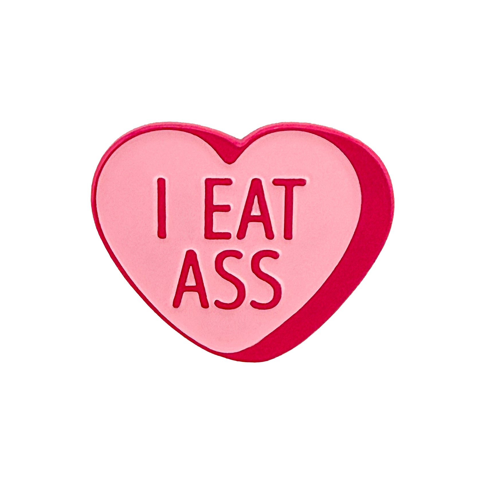 The Logie Joe's Golf I Eat A** Candy Heart Ball Marker is a pink, heart-shaped marker featuring "I EAT ASS" in bold red letters.