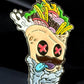 The Burrito Ball Marker by Crown Golf Designs features a cartoon burrito wrap with pink X eyes, mustache, blue tongue, fries and veggie fillings, playful expression, and magnetic hot sauce on a dark background.