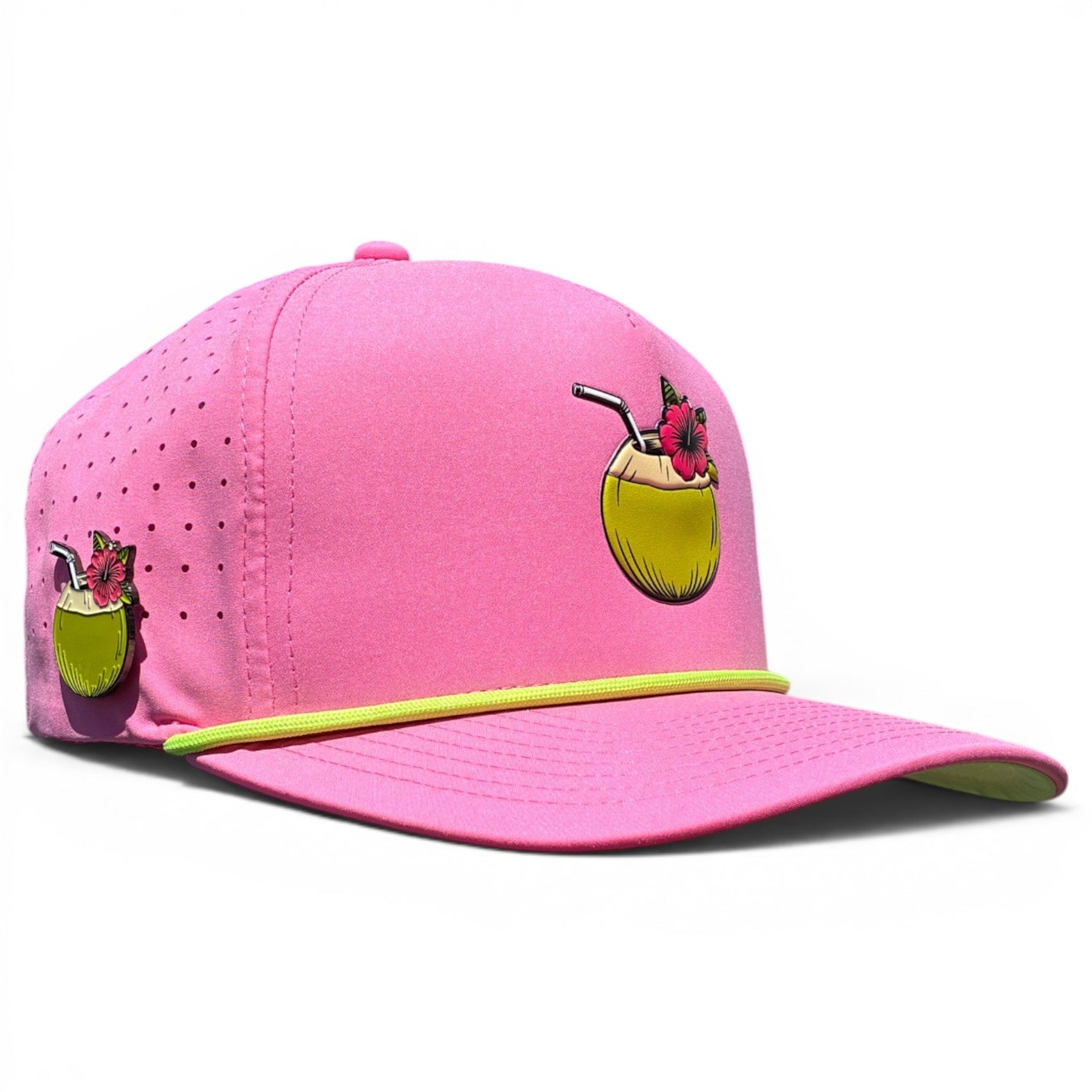 The Logie Joe's Golf Coconut Cocktail Golf Hat is a bright pink snapback cap with a yellow-green cord, coconut drink illustration, side enamel pin, adjustable fit, and built-in magnetic ball marker holder with marker included.