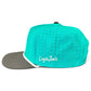 Sure! Here’s your rewritten sentence incorporating the given product data: The Mountain Moonrise Golf Hat by Logie Joe’s Golf is a turquoise outdoor snapback cap with a gray brim, small ventilation holes, and “Logie Joes” embroidered in white on the side. It features an adjustable snapback for a custom fit and includes a built-in magnetic ball marker holder with marker included.
