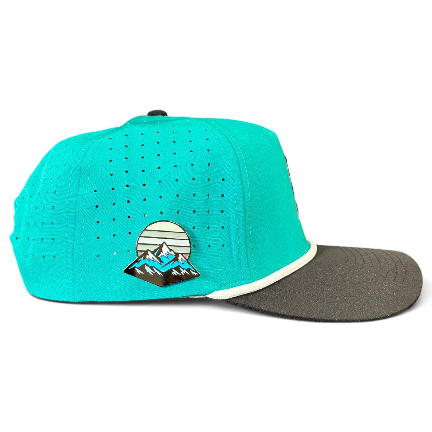 Introducing the Mountain Moonrise Golf Hat by Logie Joe’s Golf—a turquoise and black adjustable snapback cap featuring ventilation holes, a dark grey brim, and a mountain scene with a striped sky patch. Built for outdoor golfing, it includes a magnetic ball marker holder with marker.