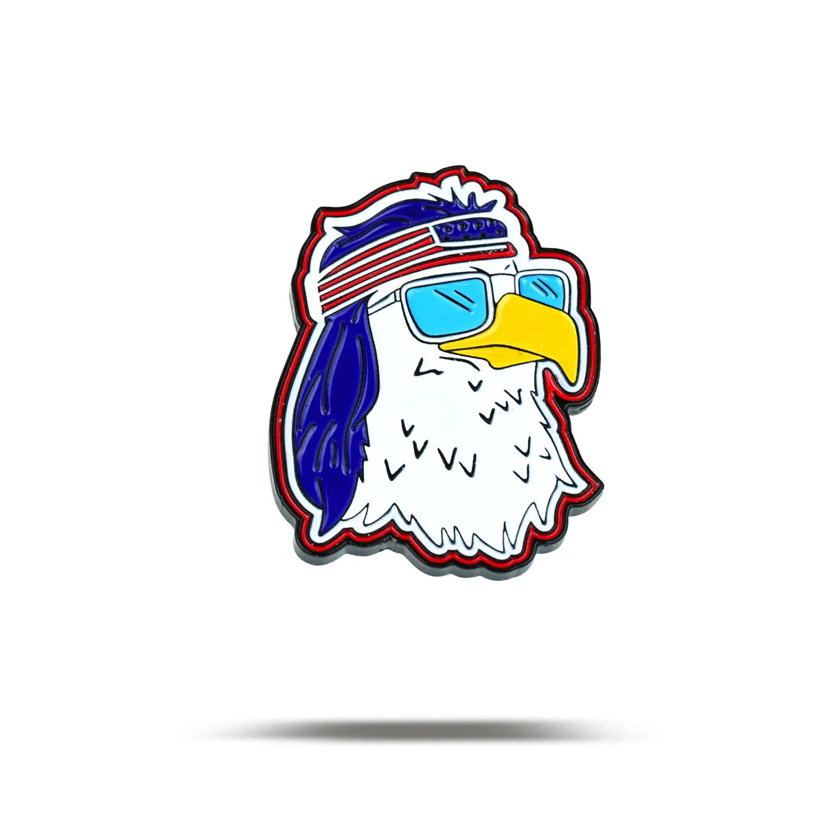 The FREEagle by Bogey Bros features a cartoon American Eagle head with blue sunglasses and a red, white, and blue headband, sporting a cool look. This free image has a white background and a subtle shadow under the eagle.
