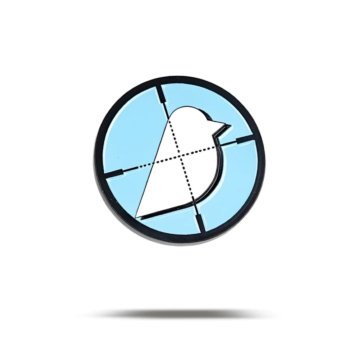 The Birdie Hunter pin by Bogey Bros features a white bird silhouette on a light blue background with black crosshairs, symbolizing the universal pursuit of freedom, and casts a subtle shadow on a white surface.