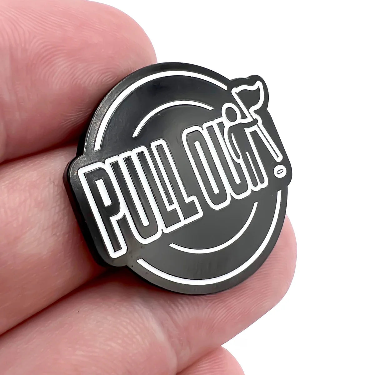 A hand holds a round black Bogey Bros pin reading PULL OUT! in bold white letters, with the T stylized as a sperm—a daring accessory that encourages playing it safe.