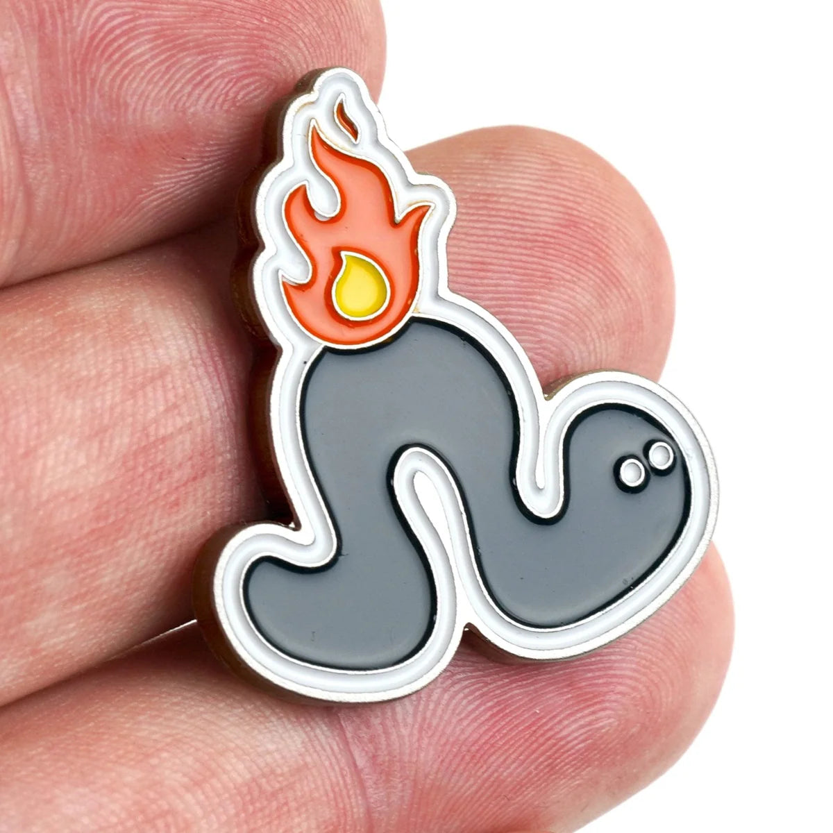 A hand holds the Bogey Bros "Worm Burner" pin, featuring a cartoon wave with fire and yellow flame—blending water and fire in a fun design that's a unique golf gift for players who love golf humor.