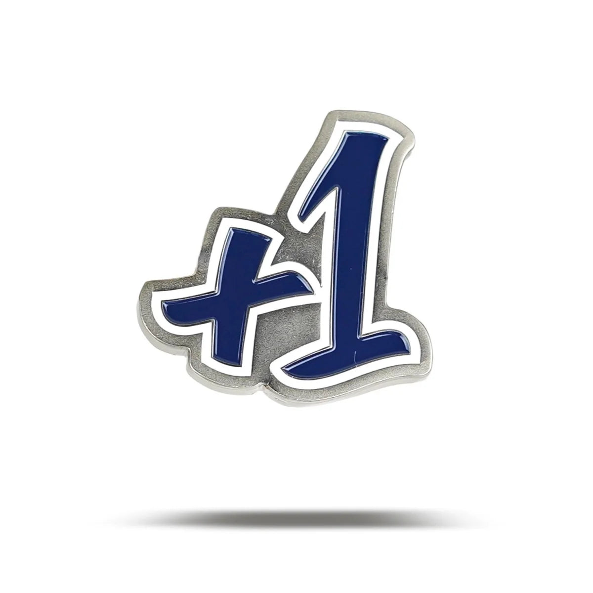 A metal pin by Bogey Bros shaped like "+1" with bold, blue and white stylized text on a white background and a subtle shadow—perfect for celebrating big numbers.