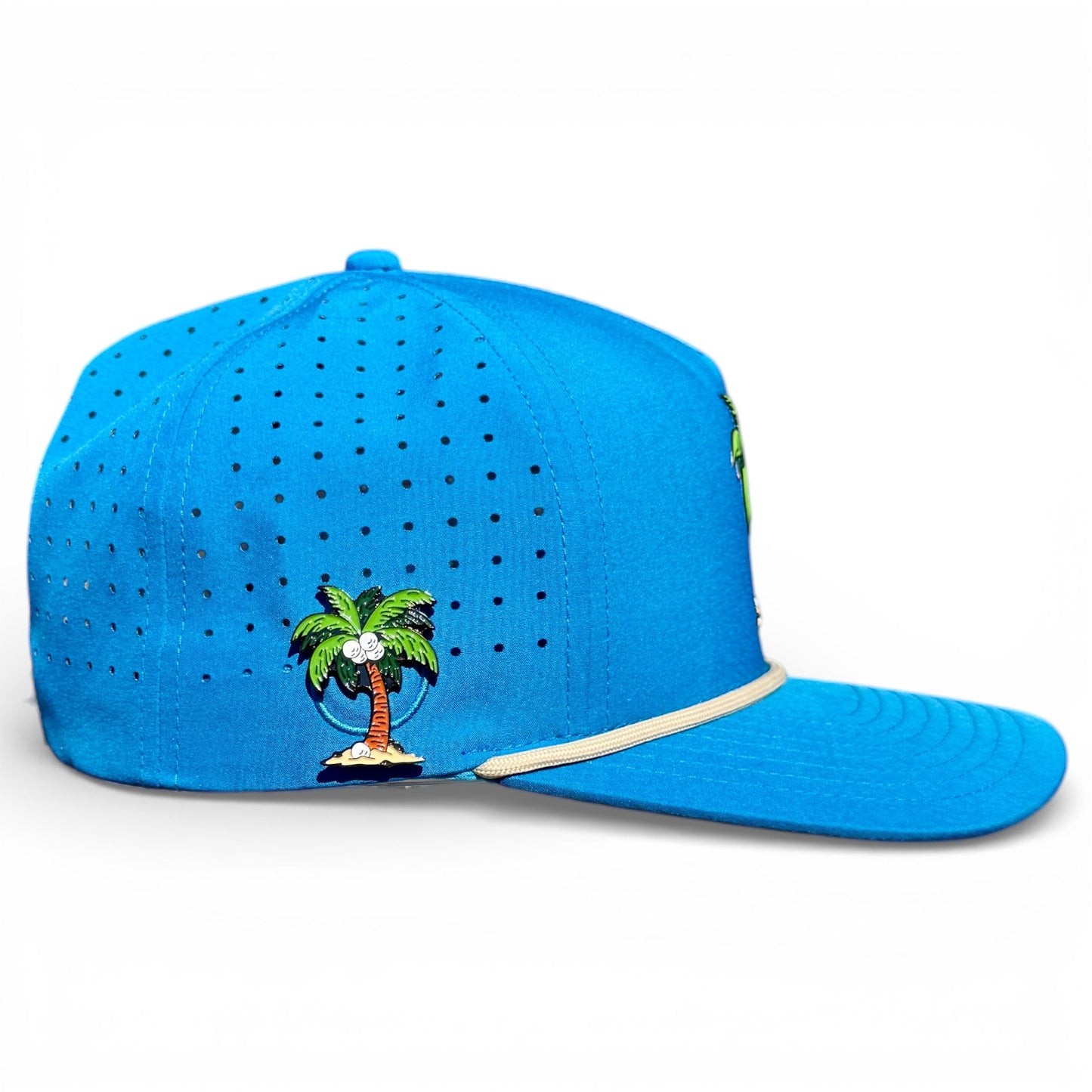 The Logie Joe's Golf Fairway Palms Snapback Cap, adjustable and one size, features a bright blue design, small embroidered palm tree, ventilation holes, beige trim above the brim, and a built-in magnetic ball marker holder with marker included.