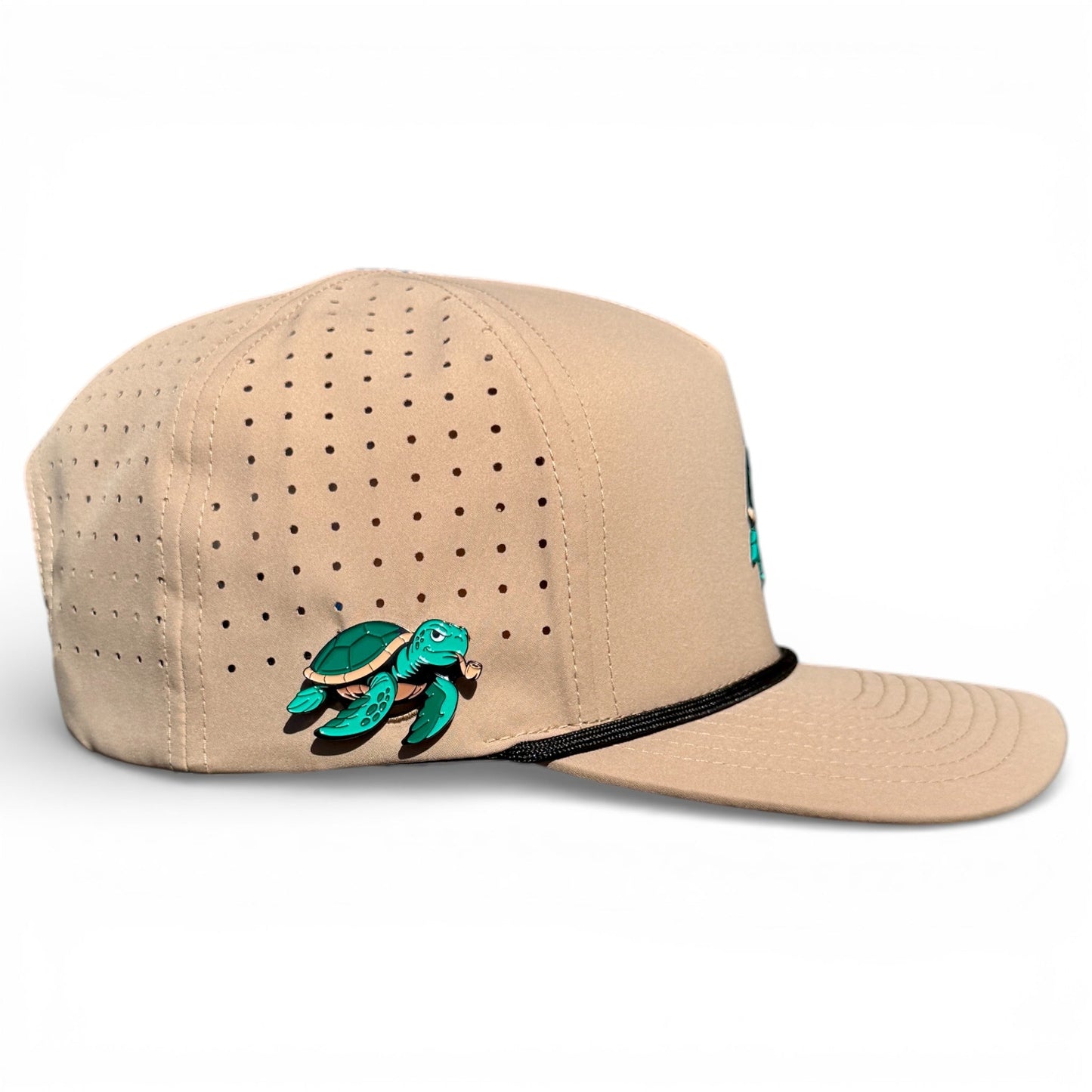 The Salty Turtle Golf Hat by Logie Joe's Golf is a beige adjustable snapback cap with a green sea turtle patch, black visor trim, and built-in magnetic holder with included turtle ball marker—perfect for stylish golfers.