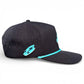The Logie Joe's Golf Shark Bite Snapback Cap features a black perforated design, turquoise rope on the brim, and a lightning bolt and fish logo, with a built-in magnetic ball marker holder and included marker. Viewed from the side on white.
