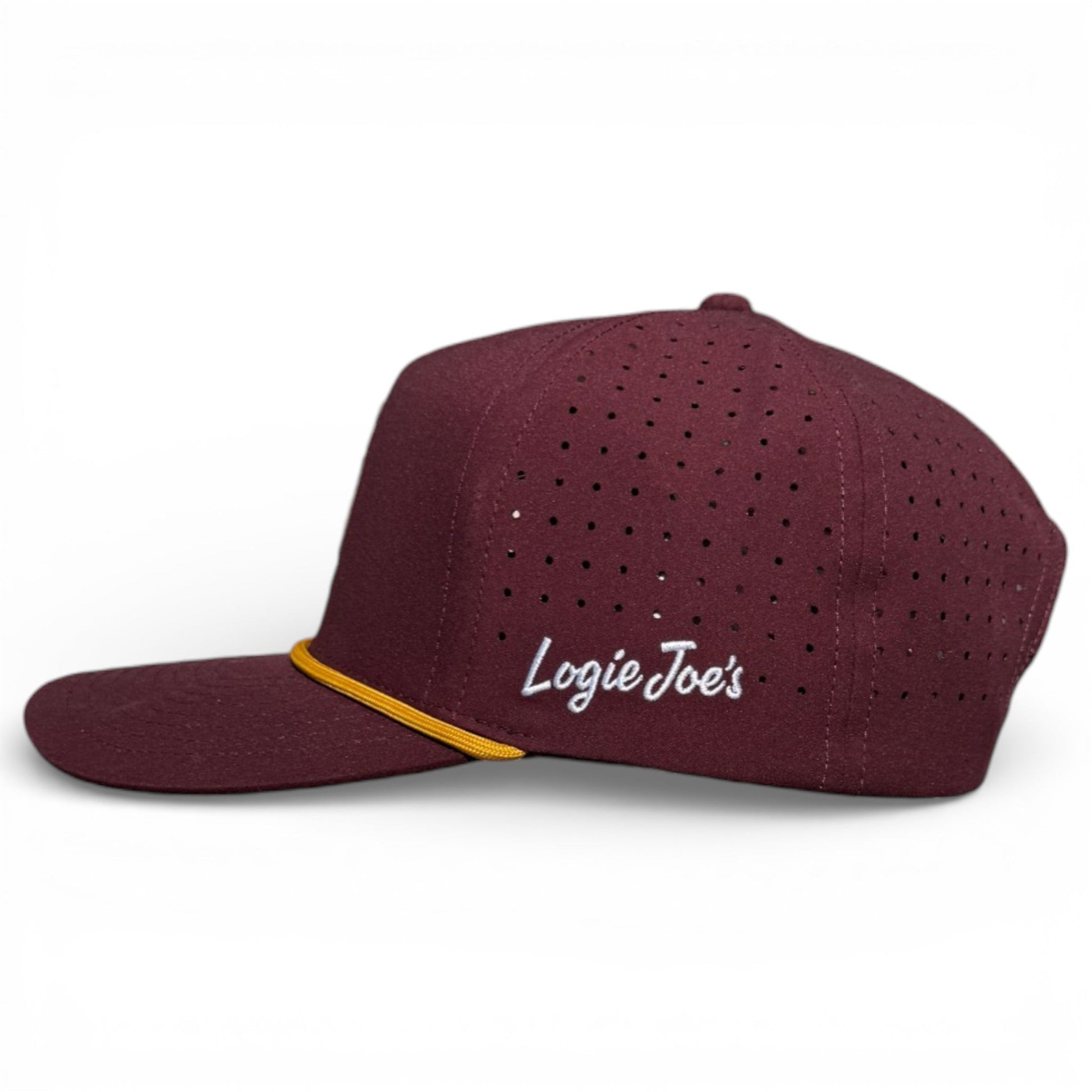 The Logie Joe's Golf Cold One Snapback Cap is a maroon adjustable golf hat with ventilation holes, flat brim, white Logie Joe's embroidery, and a yellow front cord. Features a built-in magnetic ball marker holder with marker included. One size fits most.