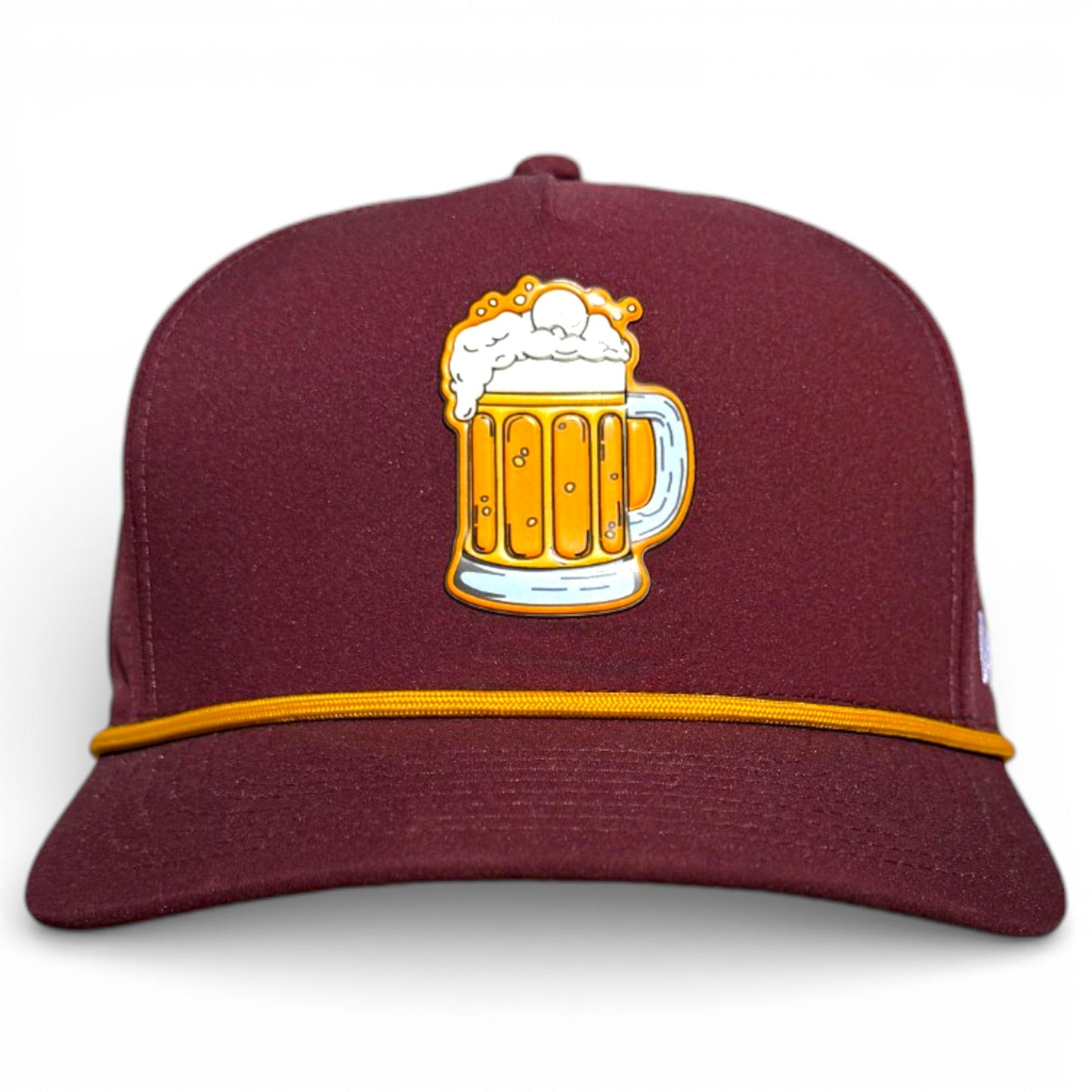 The Logie Joe's Golf Cold One Snapback Cap is a maroon adjustable hat with a yellow-gold cord, an embroidered beer mug patch, and includes a built-in magnetic ball marker holder and marker. Shown on a plain white background.