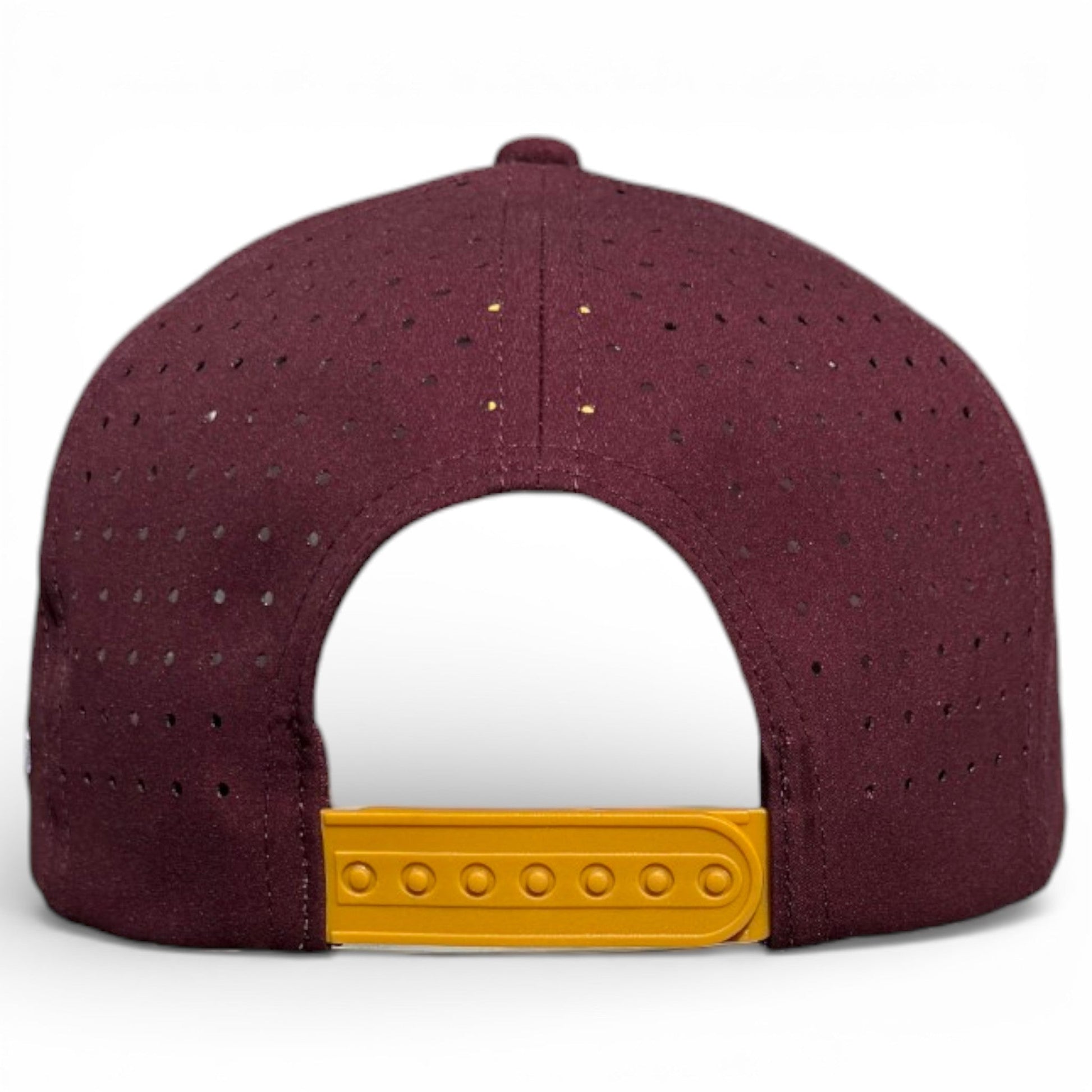 The image shows the back of a maroon Logie Joe's Golf Cold One Snapback Cap, featuring small perforated holes, a yellow adjustable strap, and a built-in magnetic ball marker holder. The background is white.
