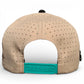 The Salty Turtle Golf Hat by Logie Joe's Golf is a beige snapback cap with ventilation holes and an adjustable teal closure, featuring a built-in magnetic ball marker holder plus marker—perfect for every round.