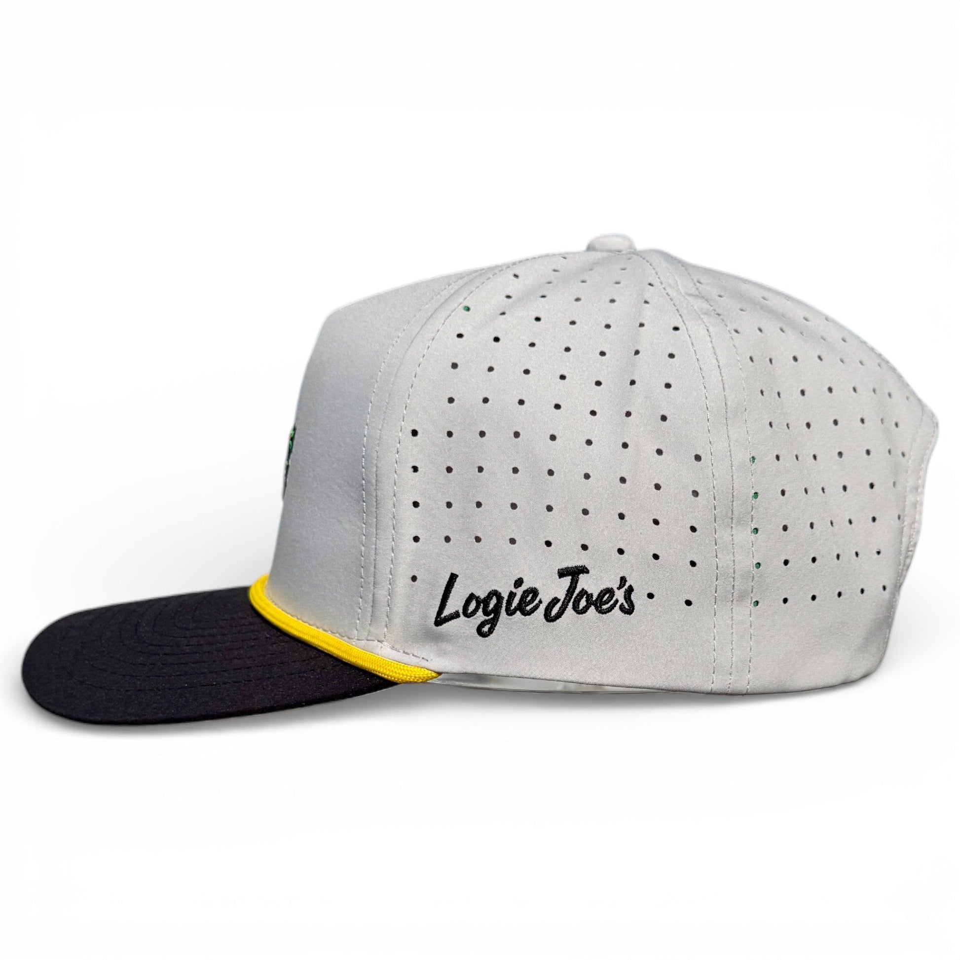 The Banana Hammock Golf Hat by Logie Joe's Golf is a white adjustable snapback with perforated sides, black brim, yellow accent, and built-in magnetic ball marker—combining style and function for every golfer.