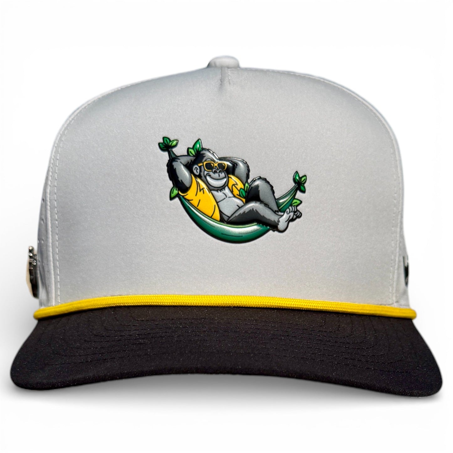 Logie Joe’s Golf Banana Hammock Snapback Cap features a relaxed gorilla in sunglasses on a gray and black hat with yellow trim, plus a built-in magnetic ball marker. Adjustable, one size—a playful vibe for the course.